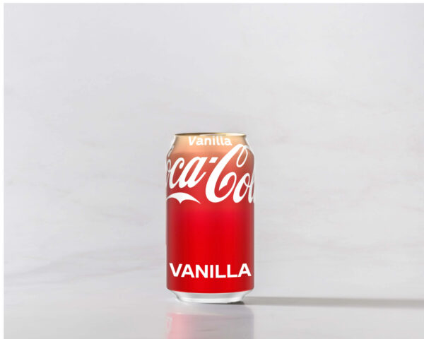 A can of Vanilla Coke original on a table with a shadow to the right. Theme white marble.