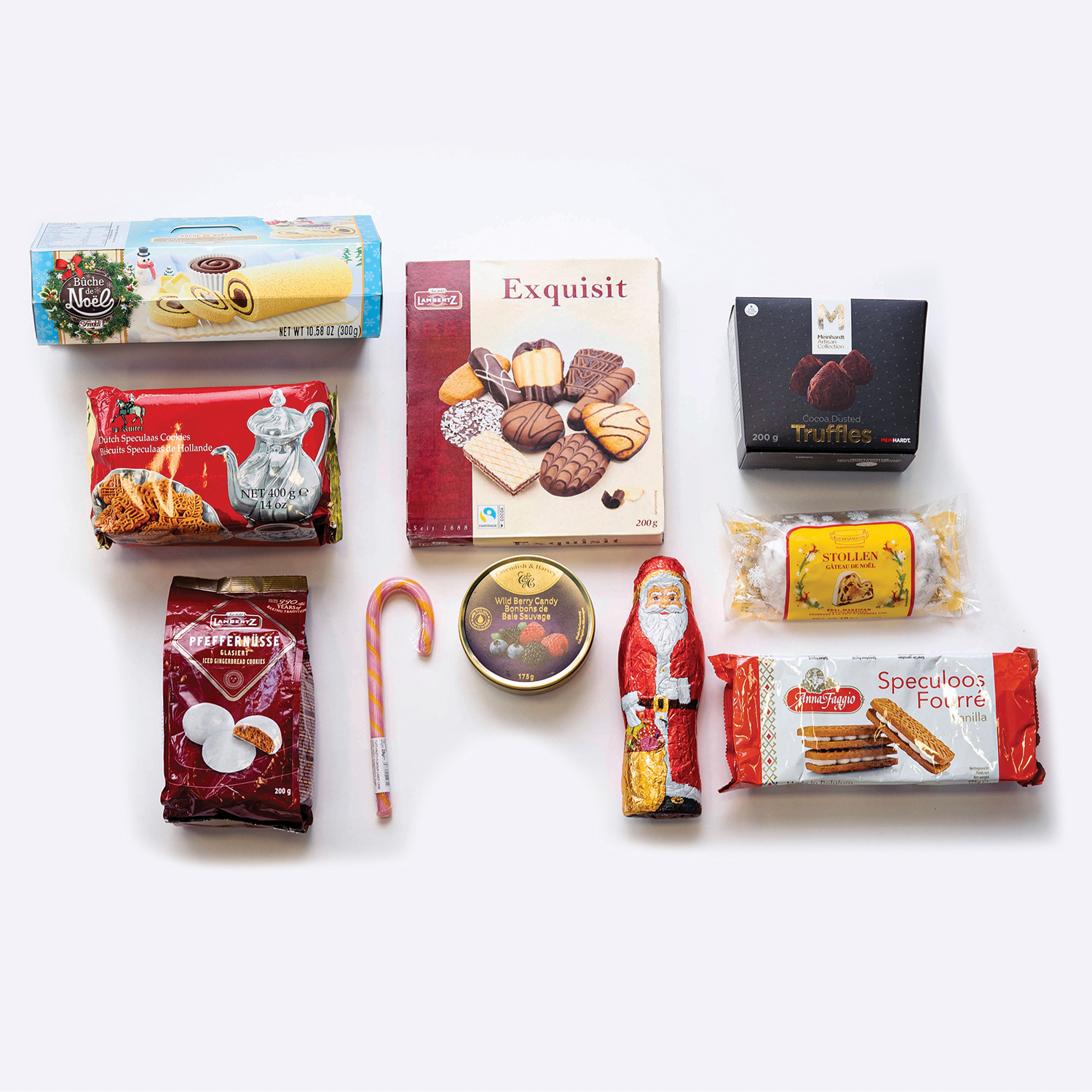 SweetHolidayCheersContents_Christmas Sweet Holiday Cheers Christmas dessert gift basket with chocolates, cookies, and festive treats laid out on white background.